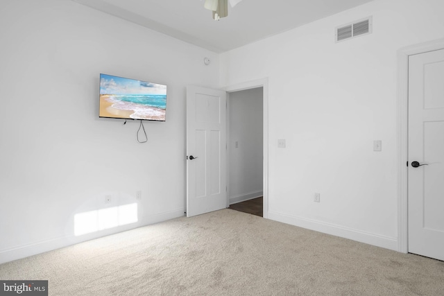 carpeted spare room with ceiling fan