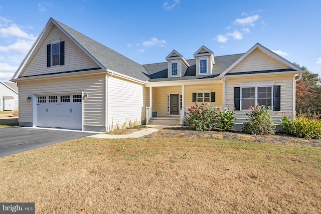 view of front facade featuring a porch, a front yard, and a garage