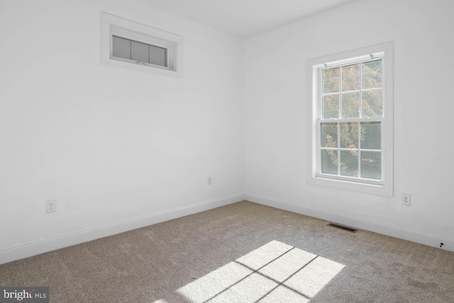 unfurnished room featuring light colored carpet