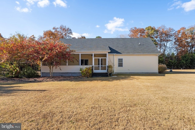 back of property featuring a yard and ceiling fan