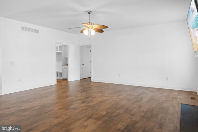 spare room featuring dark wood-type flooring and ceiling fan