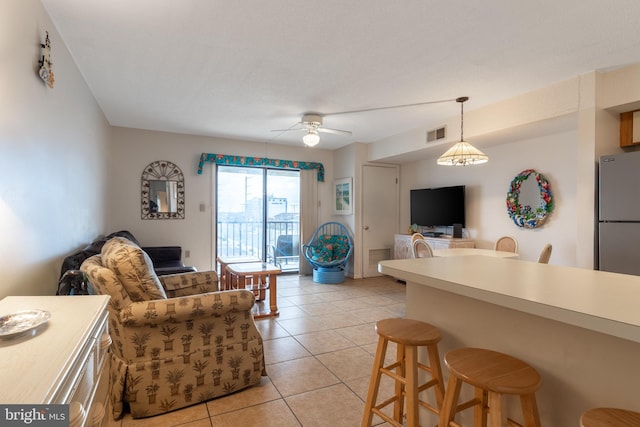 living room featuring ceiling fan and light tile patterned floors