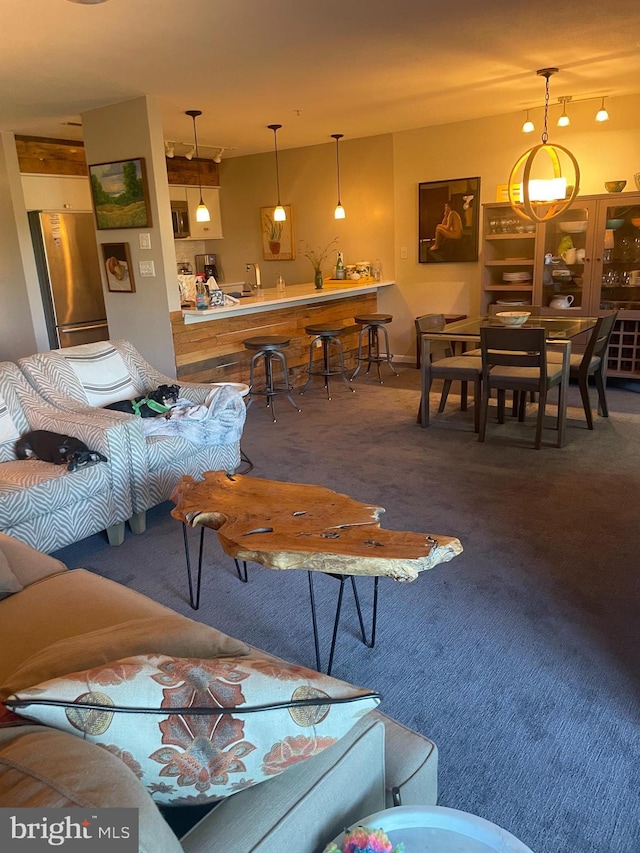 carpeted living room featuring bar area