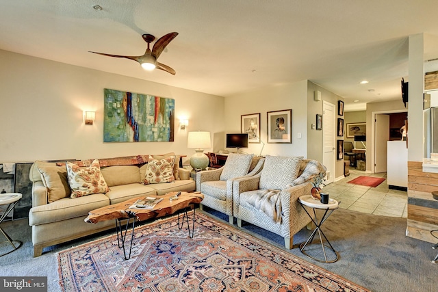 carpeted living room with ceiling fan