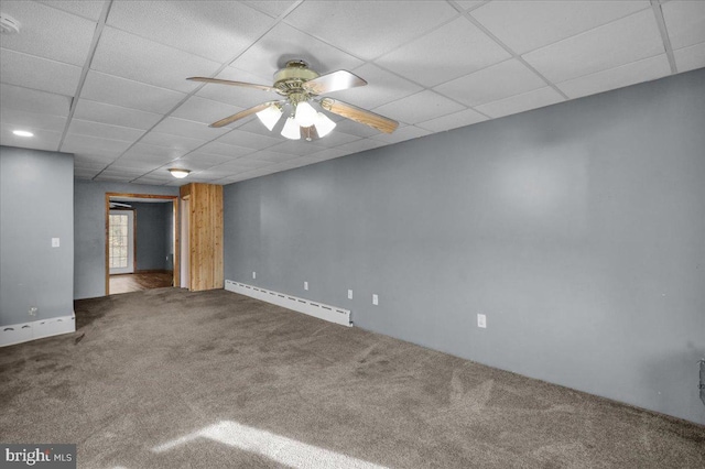 carpeted spare room featuring ceiling fan, a baseboard radiator, and a paneled ceiling