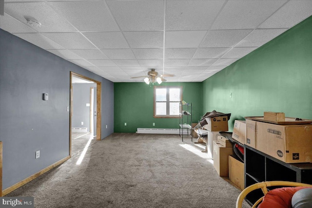 misc room featuring a drop ceiling, a baseboard heating unit, carpet flooring, and ceiling fan