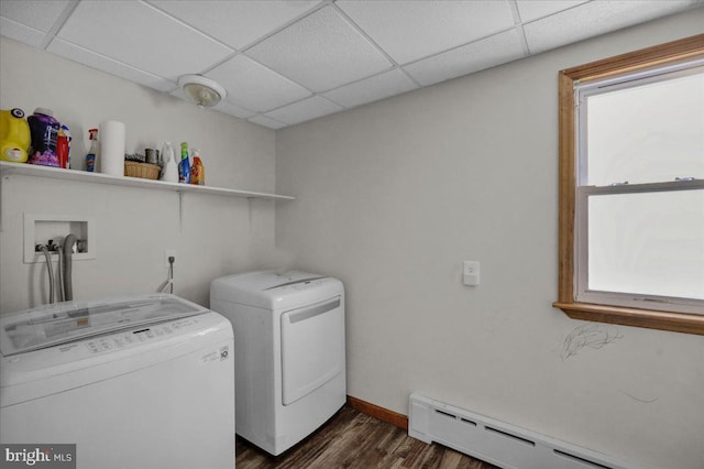 clothes washing area with a baseboard heating unit, separate washer and dryer, and dark hardwood / wood-style flooring