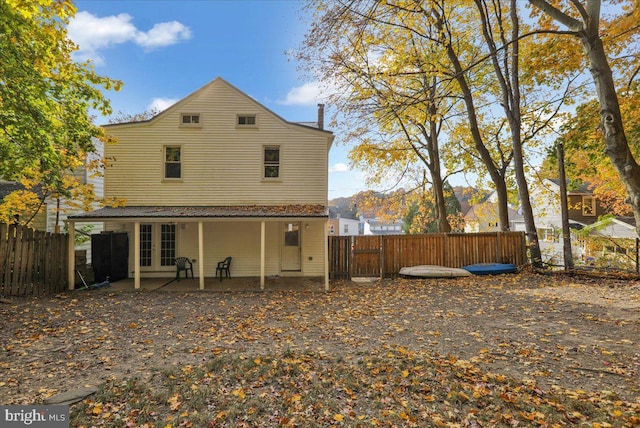 back of house featuring french doors, a mountain view, and a patio area