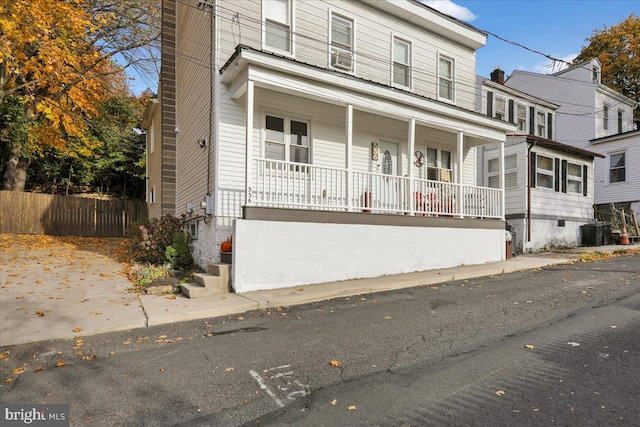 front of property with central AC and covered porch