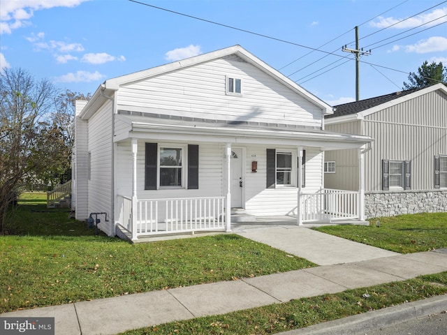 bungalow-style home featuring a front yard and covered porch