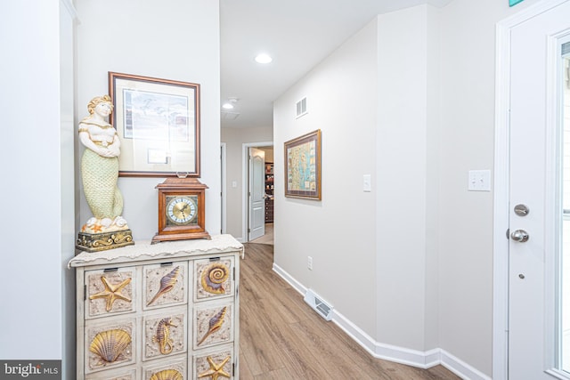 hall with hardwood / wood-style floors