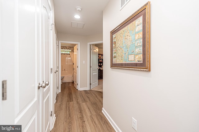 hall with light hardwood / wood-style floors