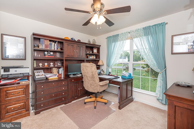 home office with ceiling fan and light carpet