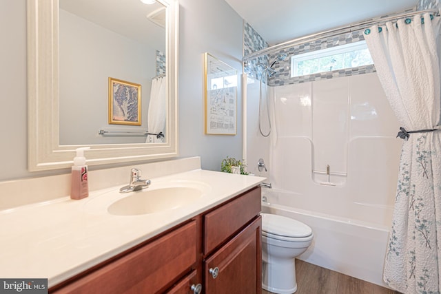 full bathroom featuring vanity, hardwood / wood-style flooring, toilet, and shower / tub combo with curtain