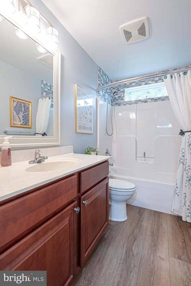 full bathroom with toilet, shower / bath combo, vanity, and hardwood / wood-style floors