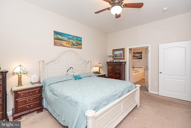 carpeted bedroom featuring ceiling fan and ensuite bath