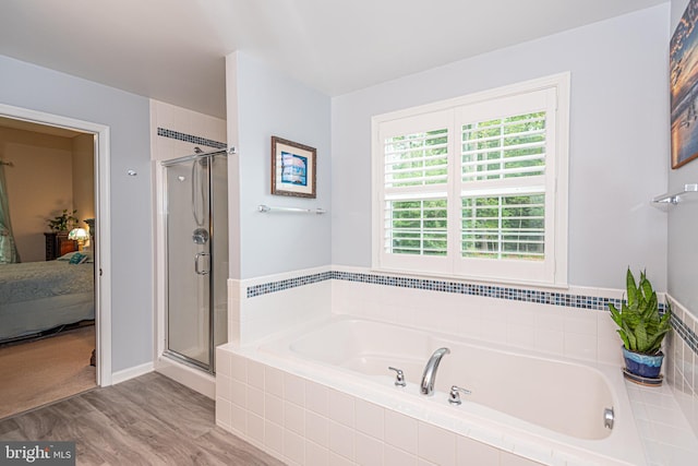 bathroom featuring wood-type flooring and independent shower and bath