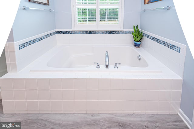 bathroom featuring tiled tub