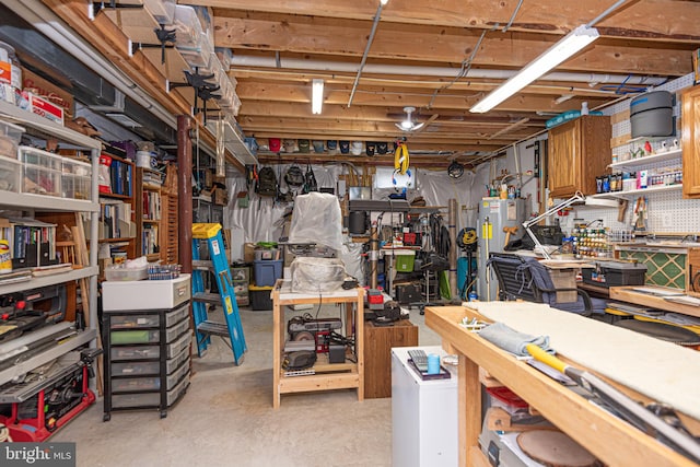 basement featuring a workshop area and water heater