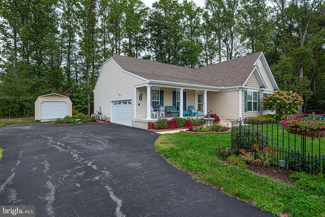 view of front of home featuring a porch, a front lawn, and a garage