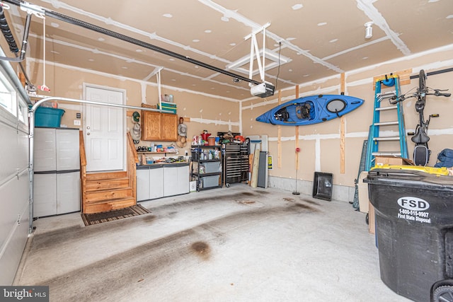 garage with a garage door opener and a workshop area