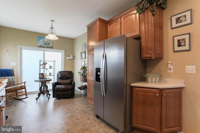 kitchen featuring stainless steel fridge with ice dispenser and pendant lighting