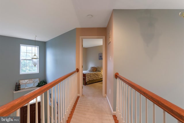 corridor featuring light colored carpet