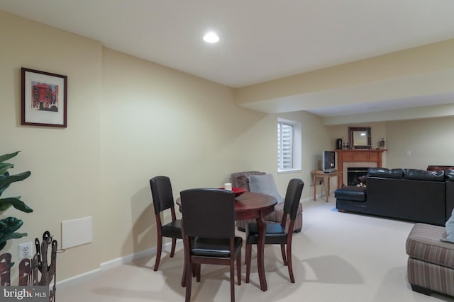 dining room featuring light carpet