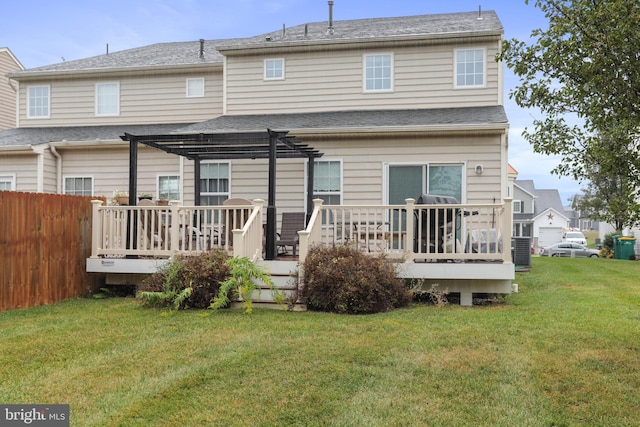 back of property with a yard, a pergola, and a wooden deck