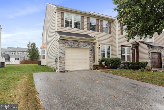 view of front of home featuring a front yard and a garage