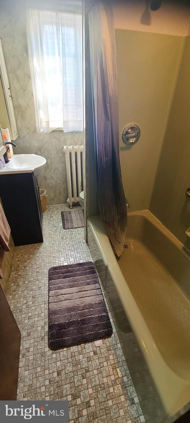 bathroom featuring radiator, toilet, and vanity