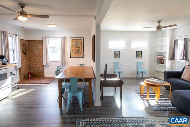 dining area with ceiling fan and dark hardwood / wood-style flooring