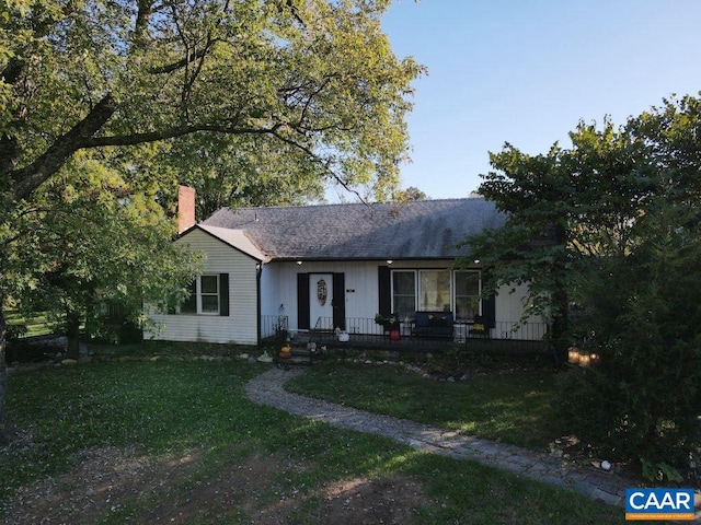 ranch-style house with covered porch and a front lawn