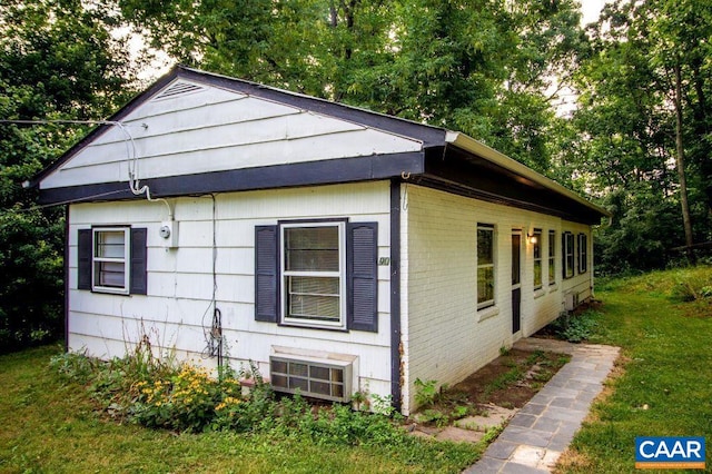 view of home's exterior with a lawn