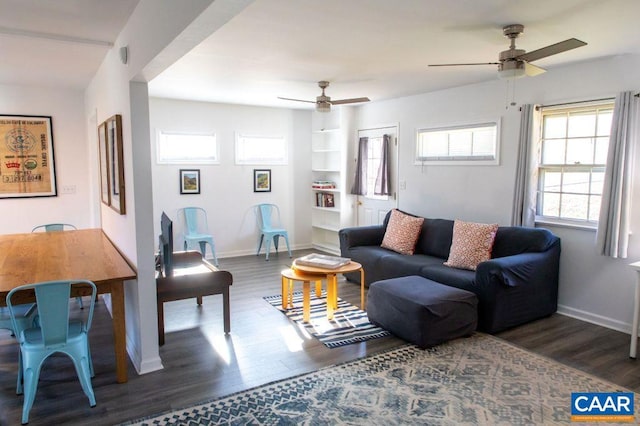 living room featuring dark hardwood / wood-style floors and ceiling fan