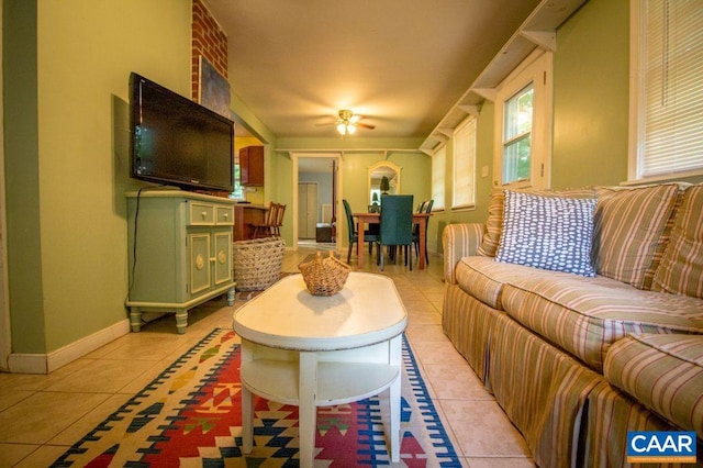 tiled living room with ceiling fan and a wealth of natural light