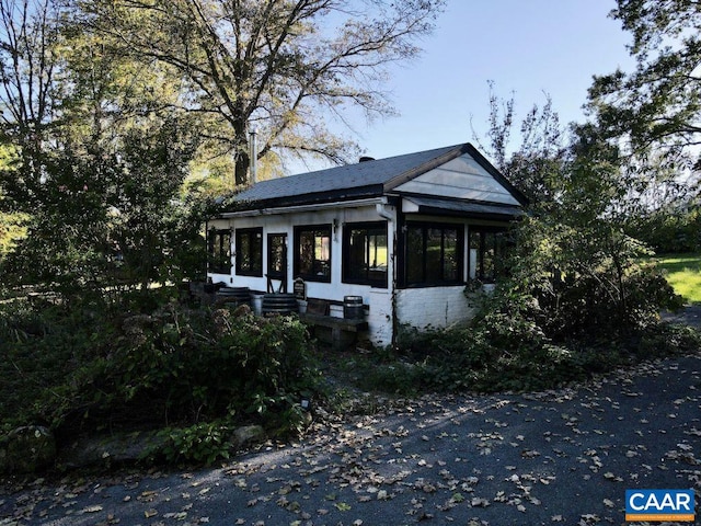 view of front of house with a sunroom