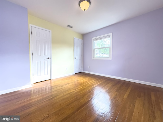 unfurnished bedroom featuring hardwood / wood-style flooring