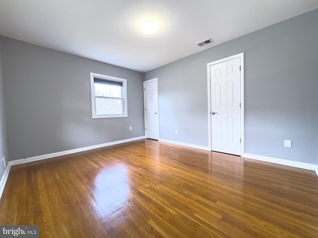 unfurnished room featuring dark hardwood / wood-style flooring