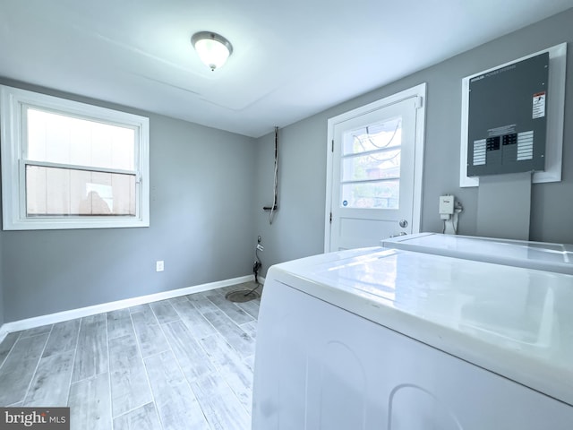 laundry room with light hardwood / wood-style flooring and washer / dryer