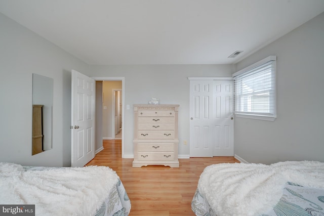 bedroom featuring light wood-type flooring and a closet