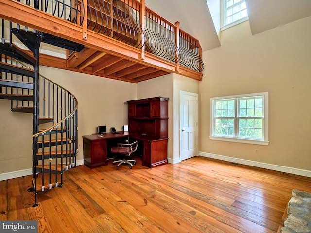 office featuring a high ceiling and hardwood / wood-style flooring