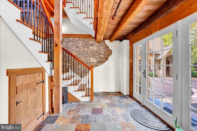 entryway with wood ceiling and beam ceiling