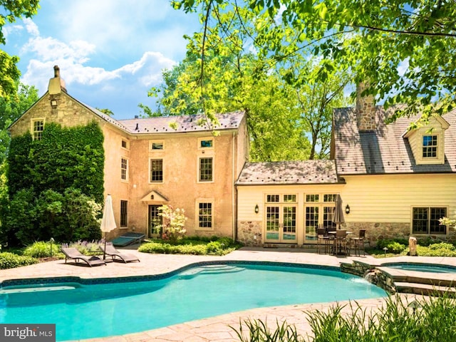 view of swimming pool with a patio and an in ground hot tub