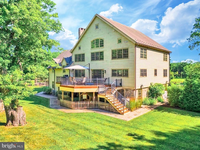 back of property featuring a patio, a yard, and a deck