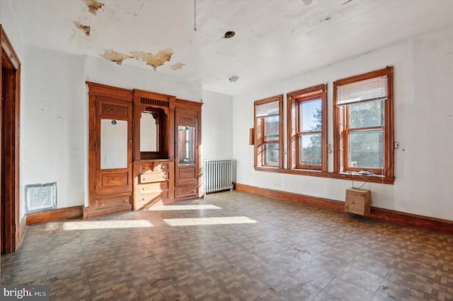 spare room featuring radiator heating unit