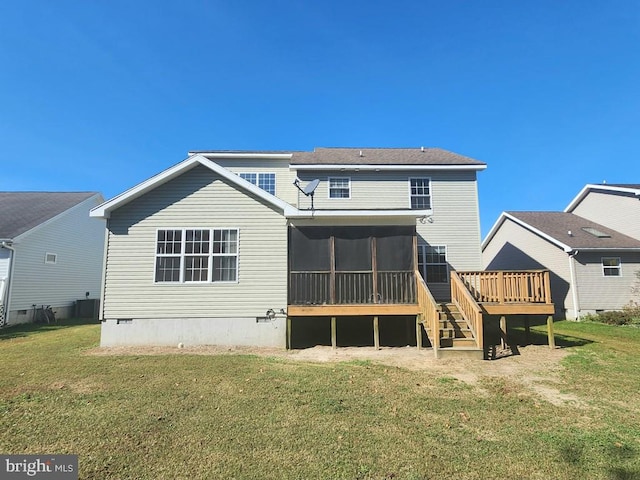 rear view of property featuring a lawn and a sunroom