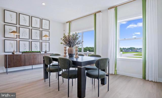 dining space with light wood-type flooring