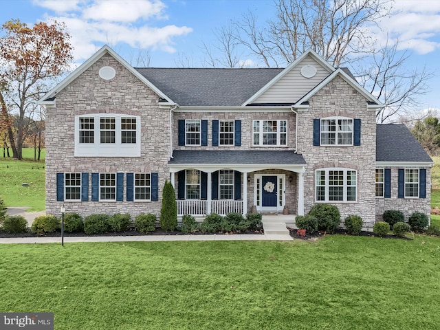 view of front of property with a front yard and covered porch