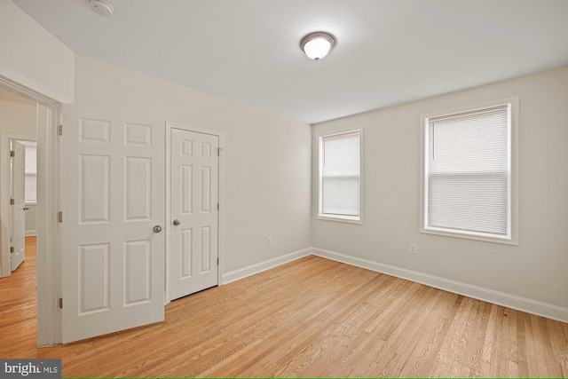 unfurnished bedroom featuring a closet and light hardwood / wood-style floors